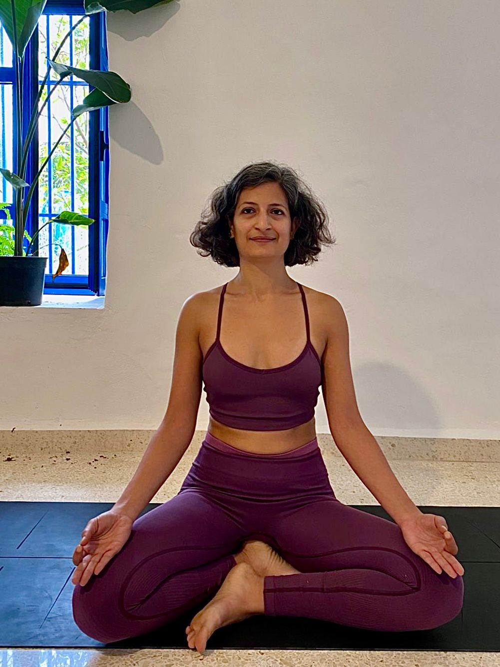 Myriam Francis seated in a quiet yoga practice